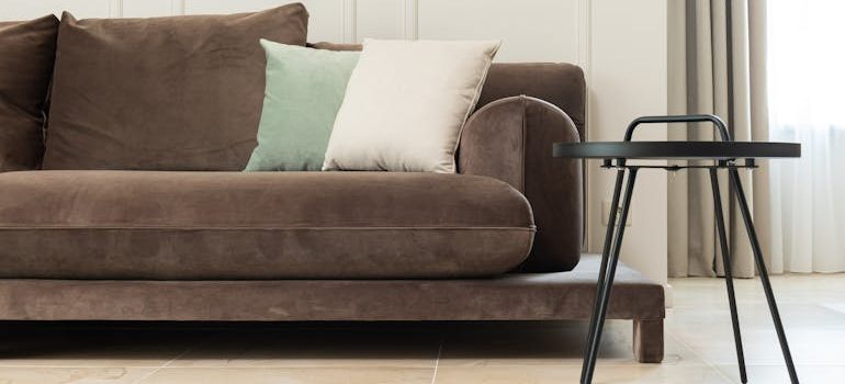Living room with sofa near table and curtains